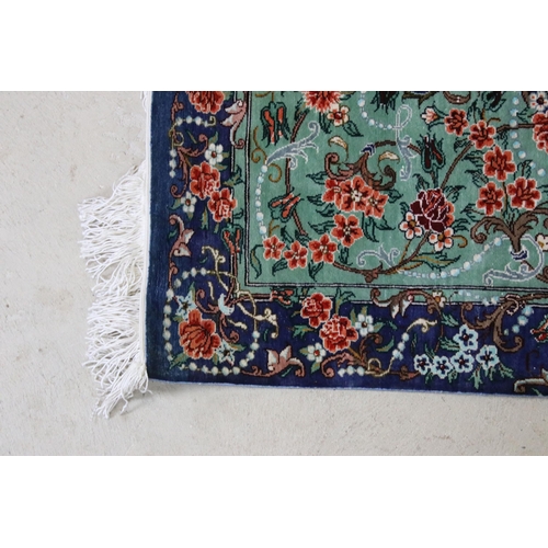 620 - 20th century Iranian silk turquoise ground prayer mat, central medallion within flowering scrolls an... 