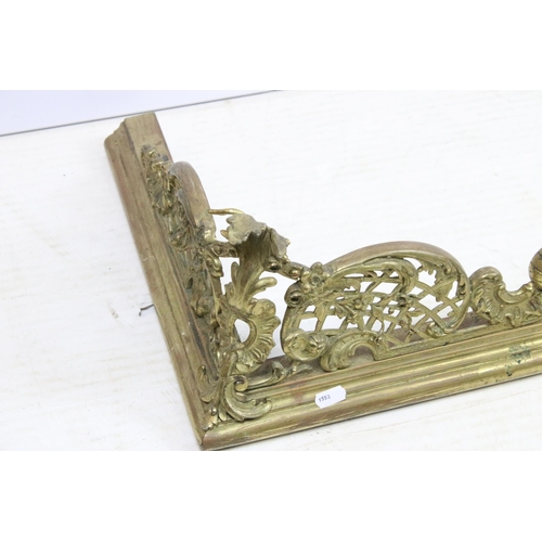 623 - Large ornate brass fire surround with scroll detailing, H 21cm, W 147cm, D 40cm