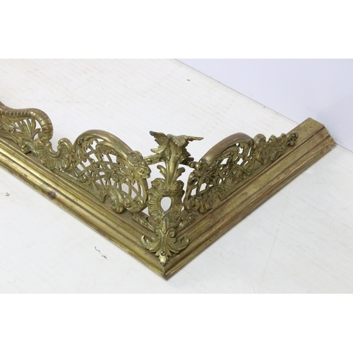 623 - Large ornate brass fire surround with scroll detailing, H 21cm, W 147cm, D 40cm