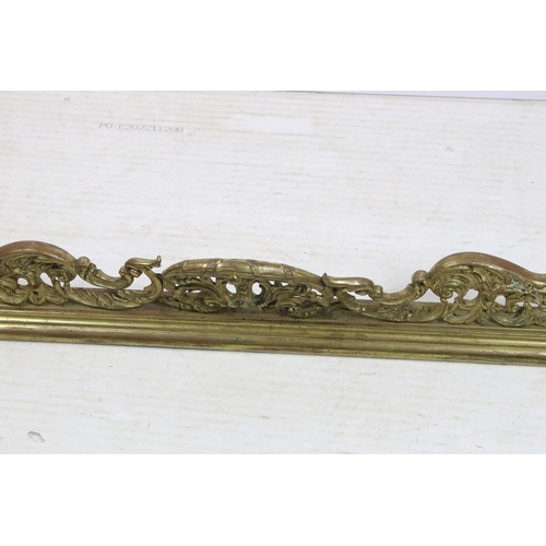 623 - Large ornate brass fire surround with scroll detailing, H 21cm, W 147cm, D 40cm