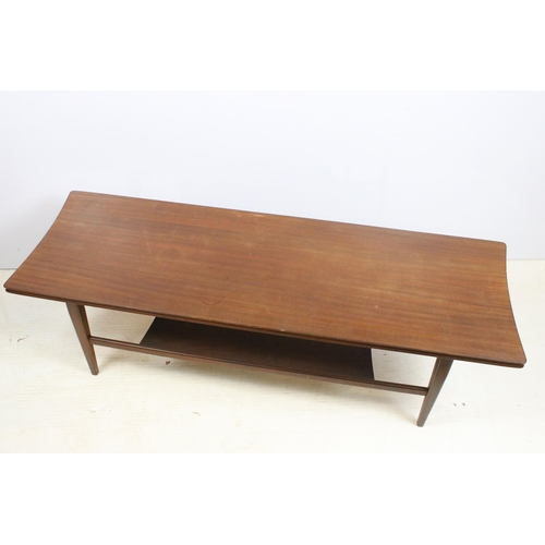 633 - Mid century hardwood shaped rectangular two tier coffee table on square tapering legs, 36cm high x 1... 