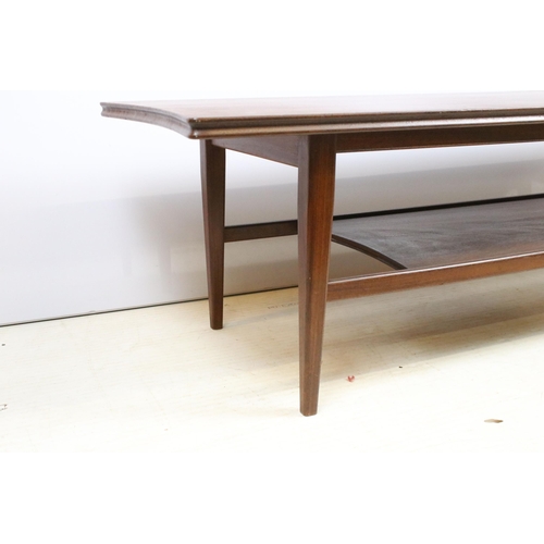 633 - Mid century hardwood shaped rectangular two tier coffee table on square tapering legs, 36cm high x 1... 