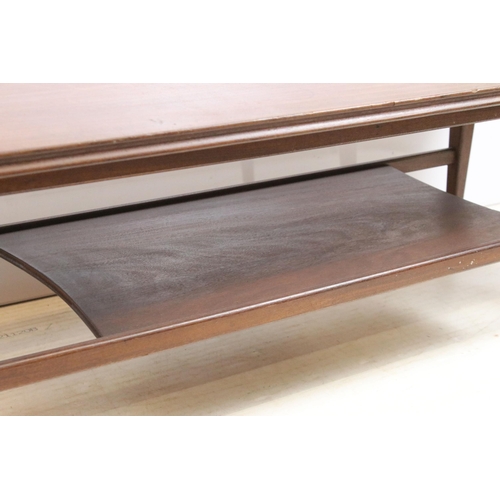 633 - Mid century hardwood shaped rectangular two tier coffee table on square tapering legs, 36cm high x 1... 