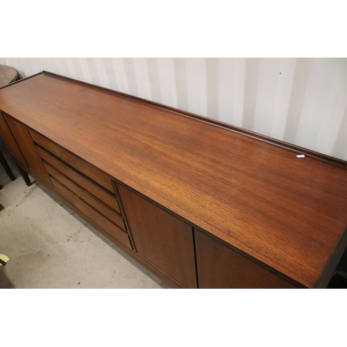 634 - Mid century teak sideboard with four drawers flanked by two pairs of cupboard doors, on square taper... 