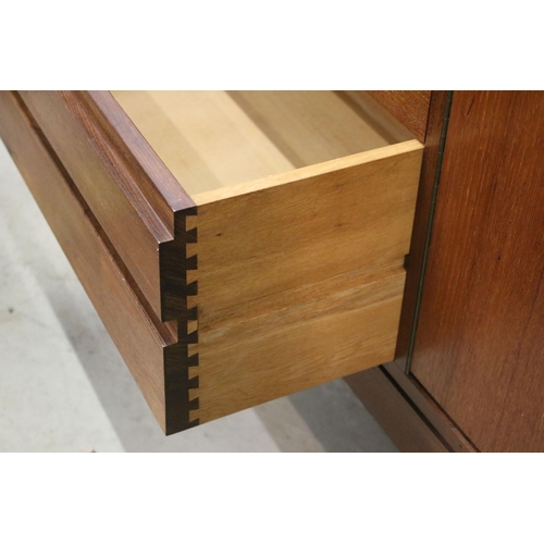 634 - Mid century teak sideboard with four drawers flanked by two pairs of cupboard doors, on square taper... 