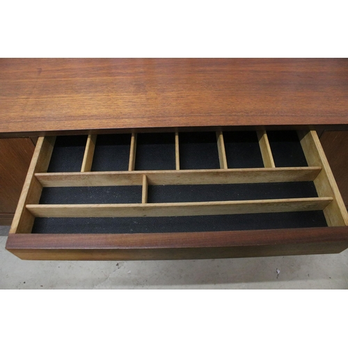 634 - Mid century teak sideboard with four drawers flanked by two pairs of cupboard doors, on square taper... 