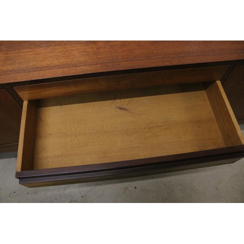 634 - Mid century teak sideboard with four drawers flanked by two pairs of cupboard doors, on square taper... 