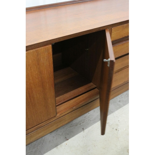 634 - Mid century teak sideboard with four drawers flanked by two pairs of cupboard doors, on square taper... 