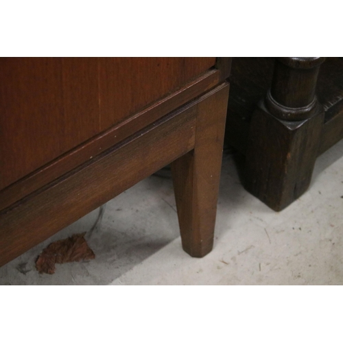 634 - Mid century teak sideboard with four drawers flanked by two pairs of cupboard doors, on square taper... 