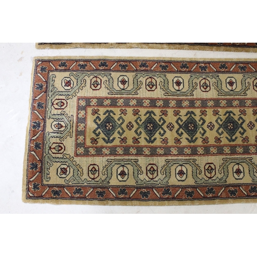 637 - Pair of 20th century cream ground wool work runners, with geometric design, each 253 x 70cm