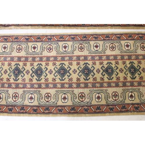 637 - Pair of 20th century cream ground wool work runners, with geometric design, each 253 x 70cm