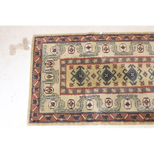 637 - Pair of 20th century cream ground wool work runners, with geometric design, each 253 x 70cm