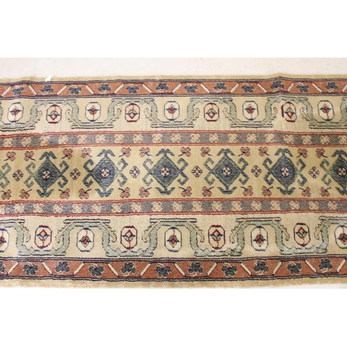 637 - Pair of 20th century cream ground wool work runners, with geometric design, each 253 x 70cm