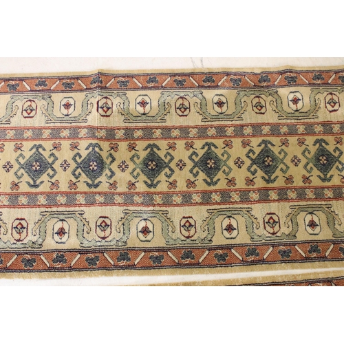 637 - Pair of 20th century cream ground wool work runners, with geometric design, each 253 x 70cm