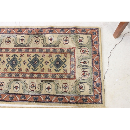 637 - Pair of 20th century cream ground wool work runners, with geometric design, each 253 x 70cm