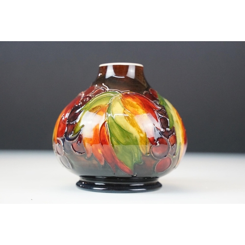 1 - William Moorcroft 'leaf and berry' pattern small vase. signed and stamped to base. H 11cm, W 11cm