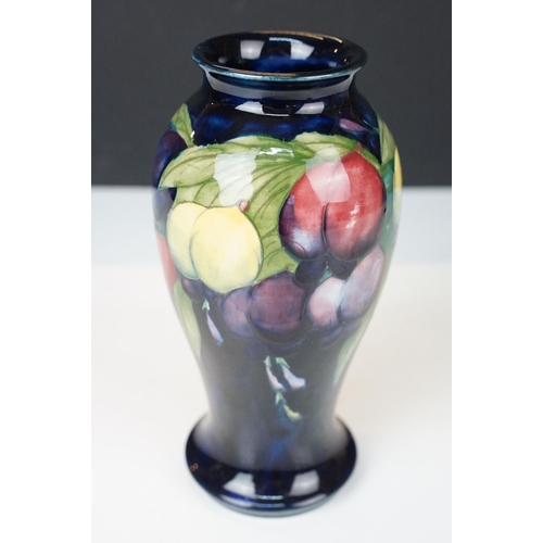 16 - Moorcroft 'Wisteria' vase H 18cm together with a Moorcroft 'Hibiscus' footed baluster form vase H 13... 