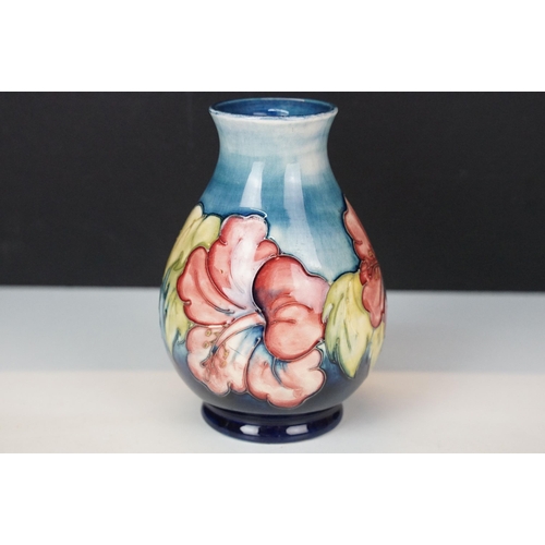 16 - Moorcroft 'Wisteria' vase H 18cm together with a Moorcroft 'Hibiscus' footed baluster form vase H 13... 