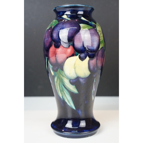 16 - Moorcroft 'Wisteria' vase H 18cm together with a Moorcroft 'Hibiscus' footed baluster form vase H 13... 