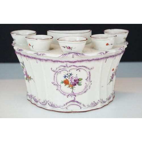 24 - Six orifice porcelain bouquetiere with floral decoration and scrolls in relief, H 12cm together with... 