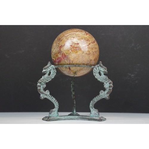 56 - Set of four decorative bone display balls together with a stone sphere on three dragon base stand