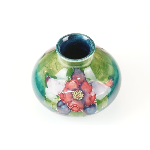 12 - William Moorcroft small floral pattern squat vase, H 6.5cm together with a Moorcroft Anemone centre ... 