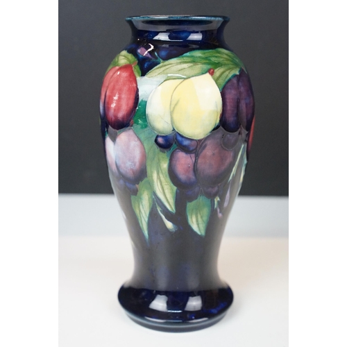 16 - Moorcroft 'Wisteria' vase H 18cm together with a Moorcroft 'Hibiscus' footed baluster form vase H 13... 