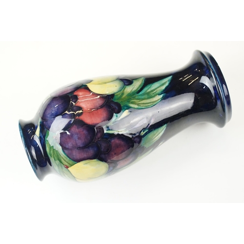 16 - Moorcroft 'Wisteria' vase H 18cm together with a Moorcroft 'Hibiscus' footed baluster form vase H 13... 