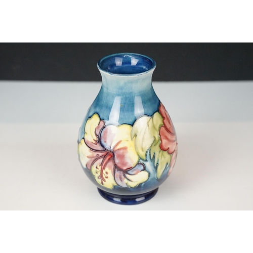 16 - Moorcroft 'Wisteria' vase H 18cm together with a Moorcroft 'Hibiscus' footed baluster form vase H 13... 