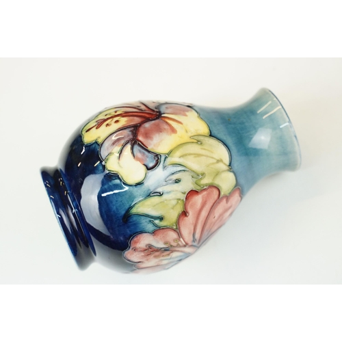 16 - Moorcroft 'Wisteria' vase H 18cm together with a Moorcroft 'Hibiscus' footed baluster form vase H 13... 