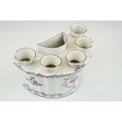 24 - Six orifice porcelain bouquetiere with floral decoration and scrolls in relief, H 12cm together with... 