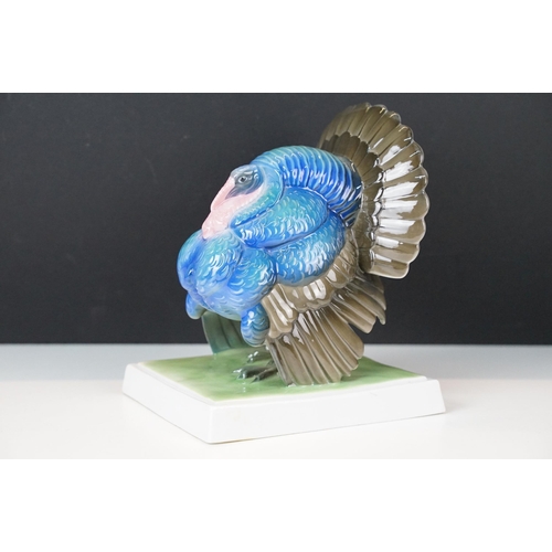 3 - Fraureuth blue painted Turkey ceramic figurine on a rectangular green plinth, marked to base, H 19cm... 