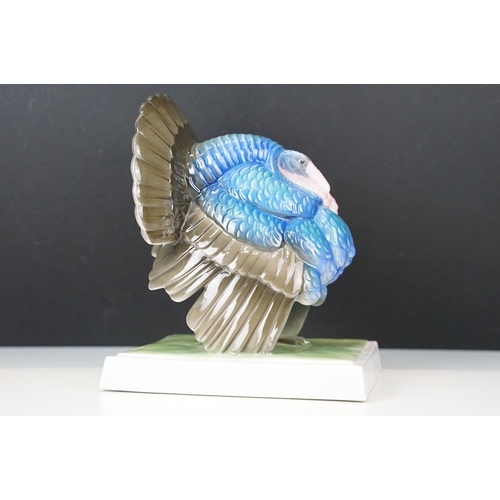 3 - Fraureuth blue painted Turkey ceramic figurine on a rectangular green plinth, marked to base, H 19cm... 