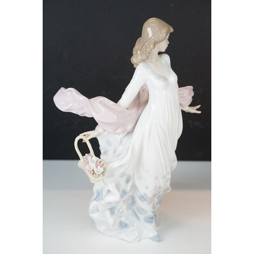 32 - Two large Lladro figurines depicting a woman in floating dress with shawl and basket of flowers, 589... 