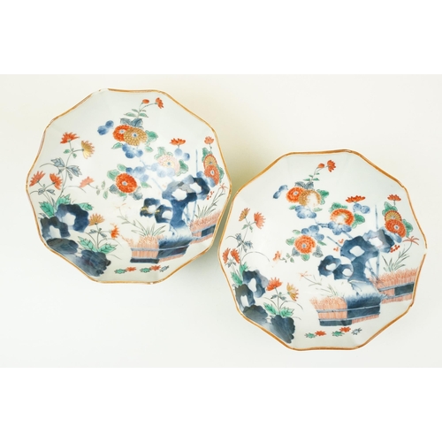 55 - Pair of decagonal Japanese hand painted Imari bowl dishes with gilt detail edges and blue outer bord... 