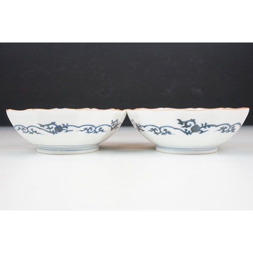 55 - Pair of decagonal Japanese hand painted Imari bowl dishes with gilt detail edges and blue outer bord... 