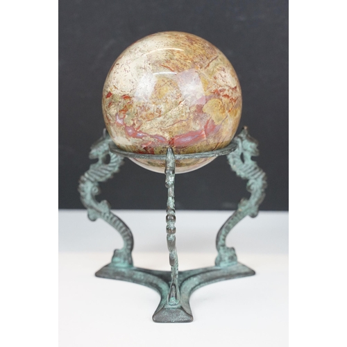 56 - Set of four decorative bone display balls together with a stone sphere on three dragon base stand