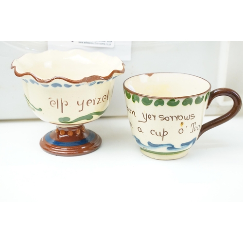 106 - Large assortment of Motto ware, Torquay and Devon ware, to include jugs, vases, plates, mugs, candle... 