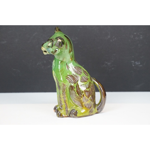 20A - C H Brannam green glazed pottery model of smiling cat, signed to base, H 17.5cm