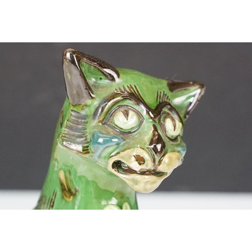 20A - C H Brannam green glazed pottery model of smiling cat, signed to base, H 17.5cm