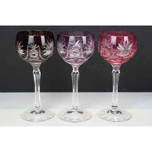 97 - Three glass decanters with etched and diamond cut examples together with an assortment of stoppers i... 