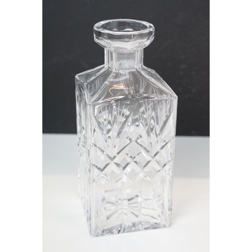 97 - Three glass decanters with etched and diamond cut examples together with an assortment of stoppers i... 