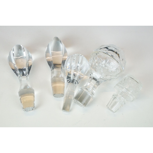 97 - Three glass decanters with etched and diamond cut examples together with an assortment of stoppers i... 