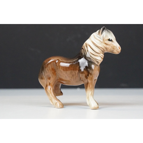 103A - Collection of ceramic figurines to include Beswick shire horses, three small horses, together with a... 