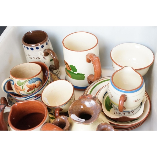 106 - Large assortment of Motto ware, Torquay and Devon ware, to include jugs, vases, plates, mugs, candle... 