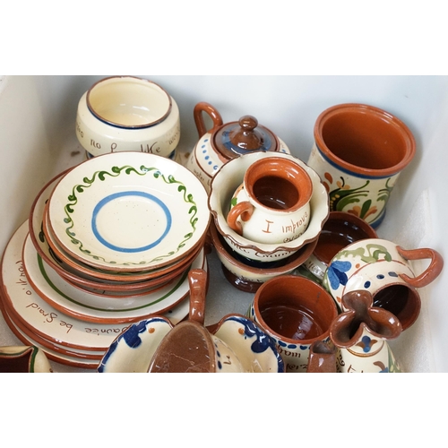 106 - Large assortment of Motto ware, Torquay and Devon ware, to include jugs, vases, plates, mugs, candle... 