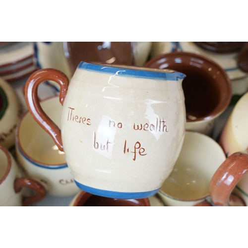 106 - Large assortment of Motto ware, Torquay and Devon ware, to include jugs, vases, plates, mugs, candle... 