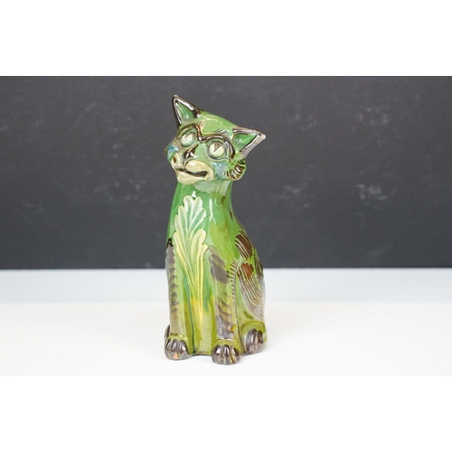 20A - C H Brannam green glazed pottery model of smiling cat, signed to base, H 17.5cm