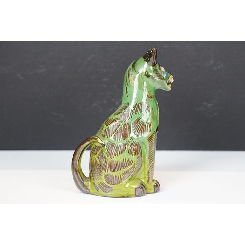 20A - C H Brannam green glazed pottery model of smiling cat, signed to base, H 17.5cm