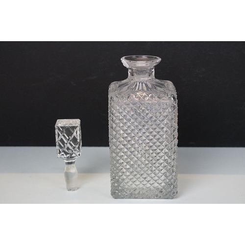 97 - Three glass decanters with etched and diamond cut examples together with an assortment of stoppers i... 